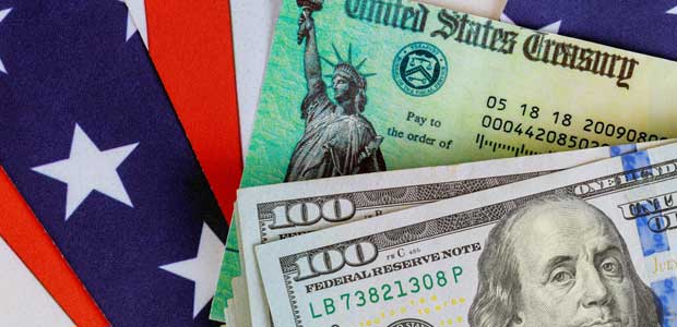 two $100 USD bills and a U.S. treasury note sit on top of pendant with stripes and stars