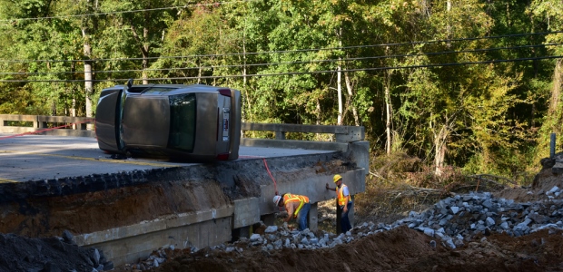 In Columbia, S.C., on Oct. 13, 2015, workers lifted a vehicle from an area that flooded; FEMA reported both bridge approaches were washed away by the floodwaters. Climate change is making floods and storms more frequent and more severe. (FEMA/Bill Koplitz photo) 