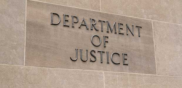 sign on stone building reading "Department of Justice"