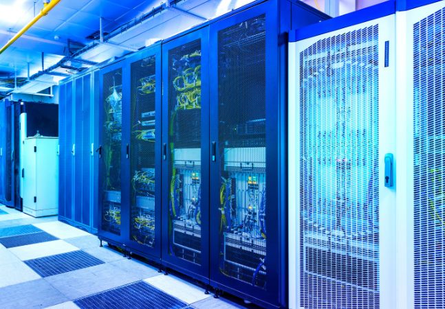 Server room with control modules in racks datacenter under blue toning