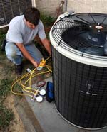 Technician testing a central air conditioning unit