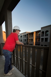 A construction worker admires New Harmony, a green affordable housing development in Davis, CA. 