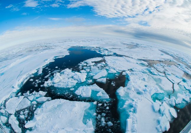Arctic Ocean sea ice and ice floes breaking up and melting