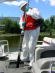 A worker collects samples using a push core sampler.