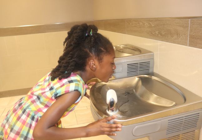 Child Drinking from a Water Fountain