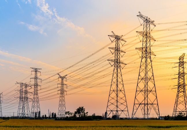 Transmission towers in open field