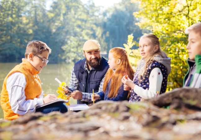 Students and teacher at a river bank