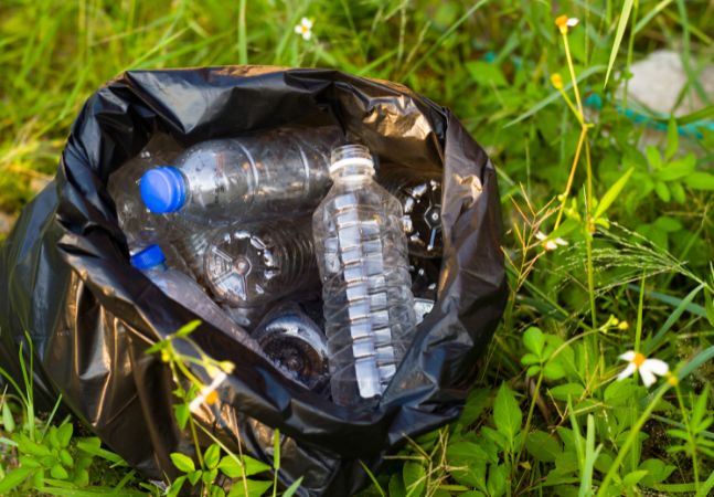 Black bag filled with discarded water bottles