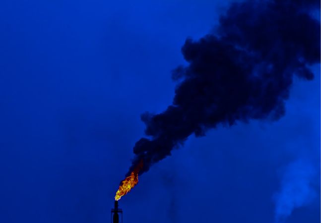 Flare stack burning at night