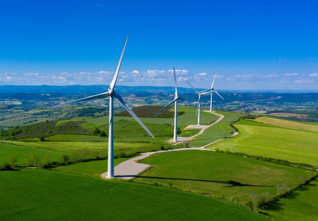 Wind turbines in green, open field 